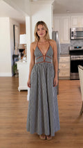 Front view of black and white striped halter maxi dress