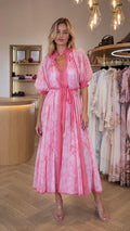 Front view of model wearing pink tie dye midi dress