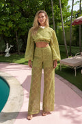 Front view of model wearing olive textured two-piece crop top and wide-leg pants set
