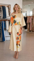 Front view of model wearing champagne one-shoulder floral satin midi dress