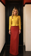 Front view of model wearing yellow mandarin collar jacket and striped maxi skirt