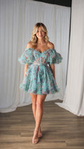 Front view of model wearing blue floral tulle mini dress