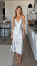 Model wearing light blue floral satin midi slip dress from the front