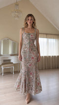 Front view of model wearing champagne floral sequin mermaid maxi dress