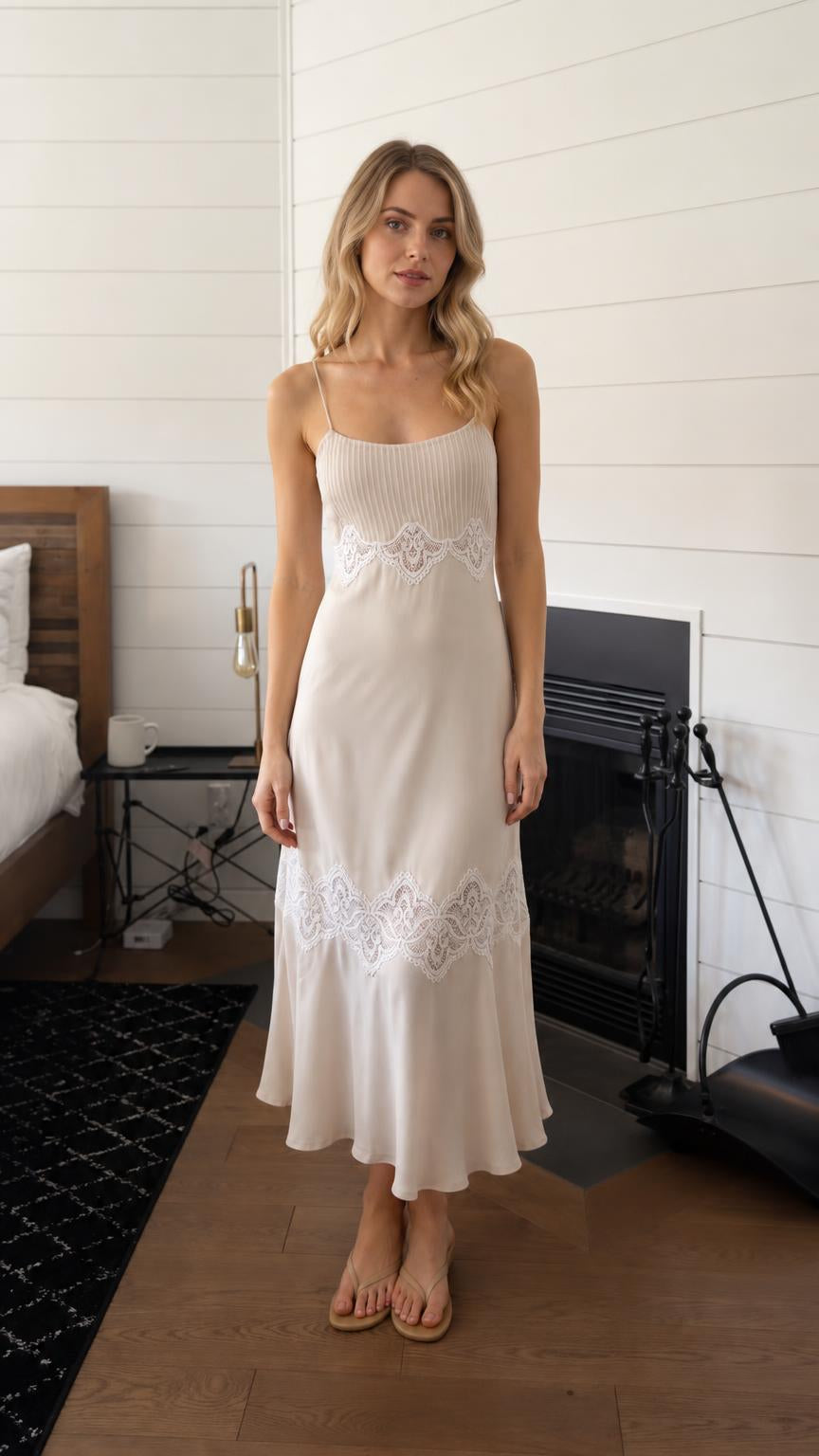 Front view of woman wearing beige lace trim pleated slip midi dress