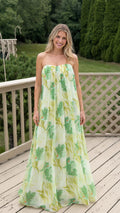 Front view of model wearing white floral strapless maxi dress