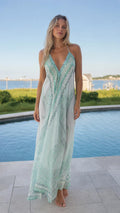 Front view of mint boho halter maxi dress by pool