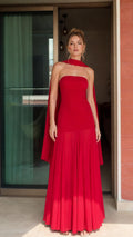 Front view of woman wearing red strapless maxi dress with matching scarf