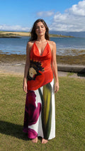 Front view of red floral halter maxi dress by the coast