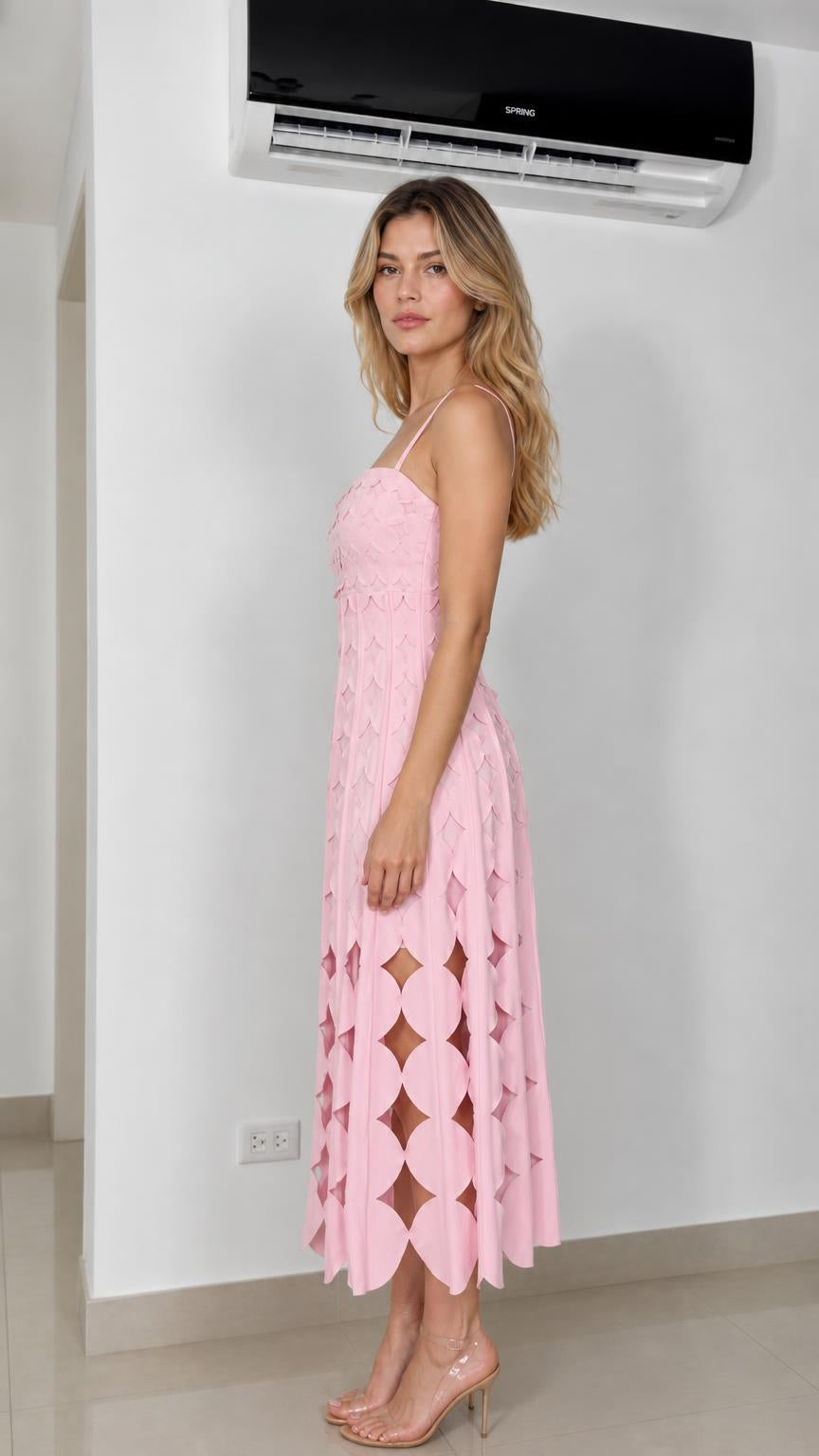 Side profile of model in pink cutout midi dress