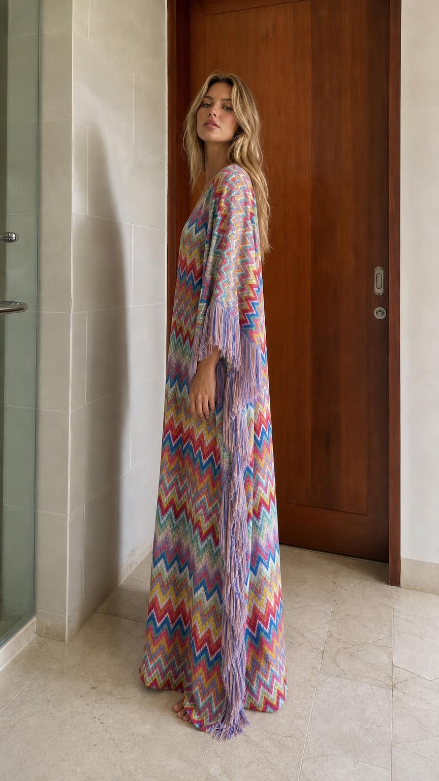 Side view of model in multi-colored chevron fringe maxi kaftan dress