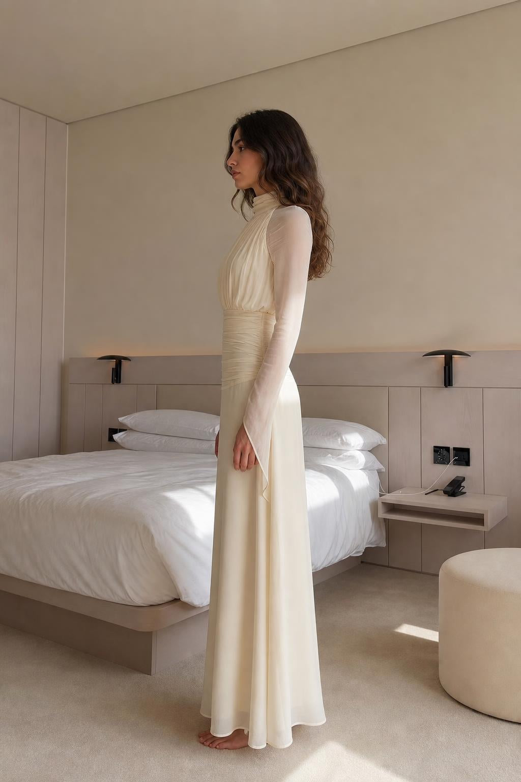 Side profile view of cream maxi dress in bedroom setting