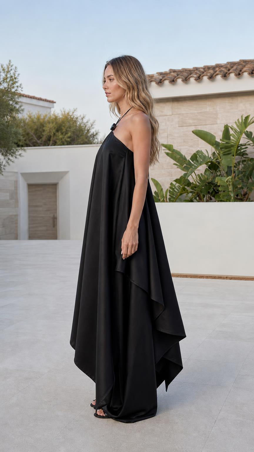 Side profile view of black wide leg jumpsuit