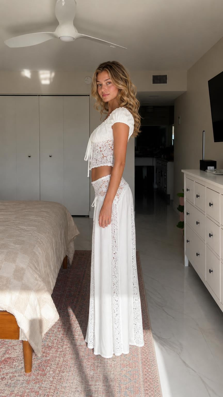 Side profile view of model in white matching crop top and maxi skirt