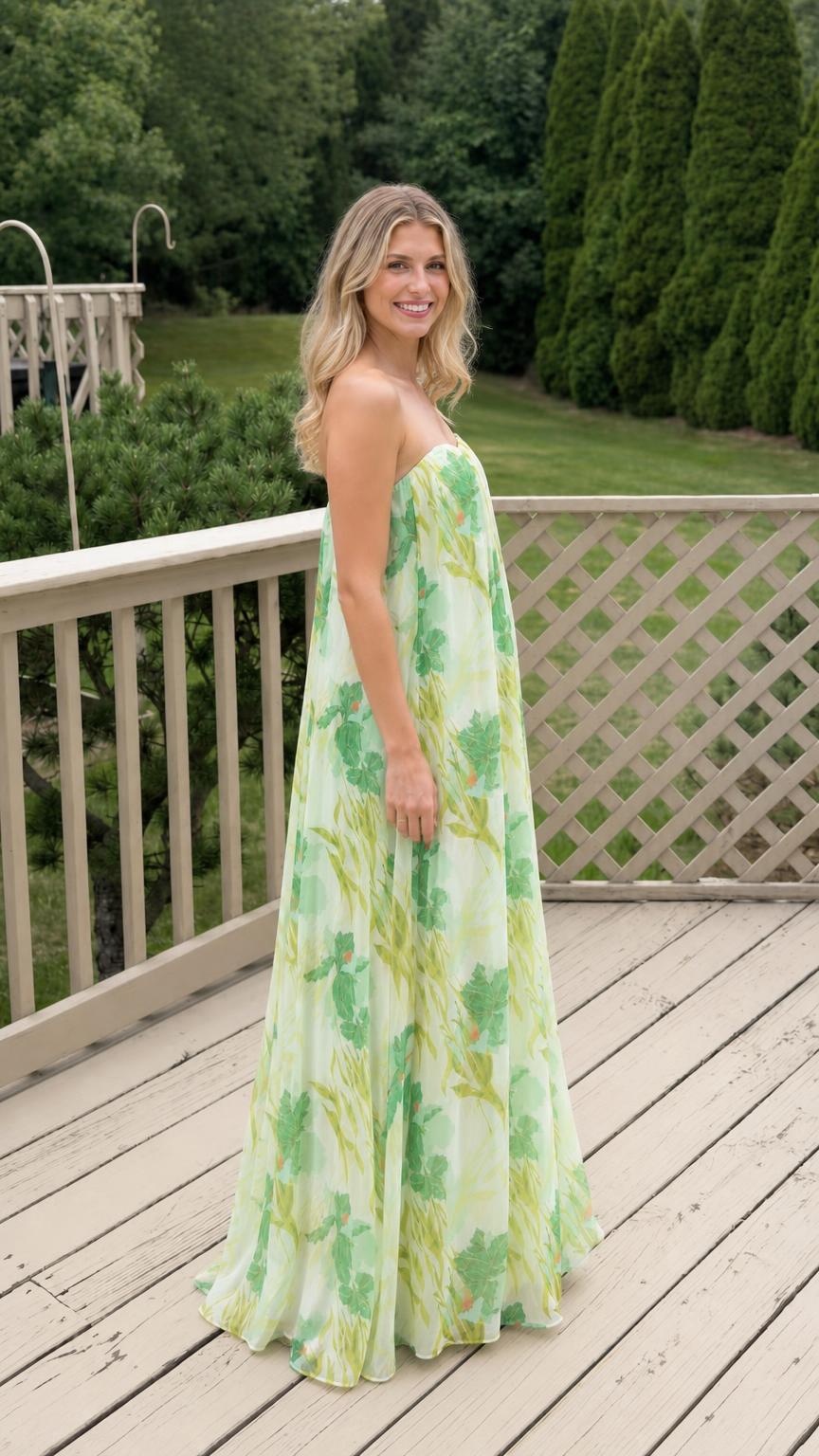 Side profile of model in white floral strapless maxi dress