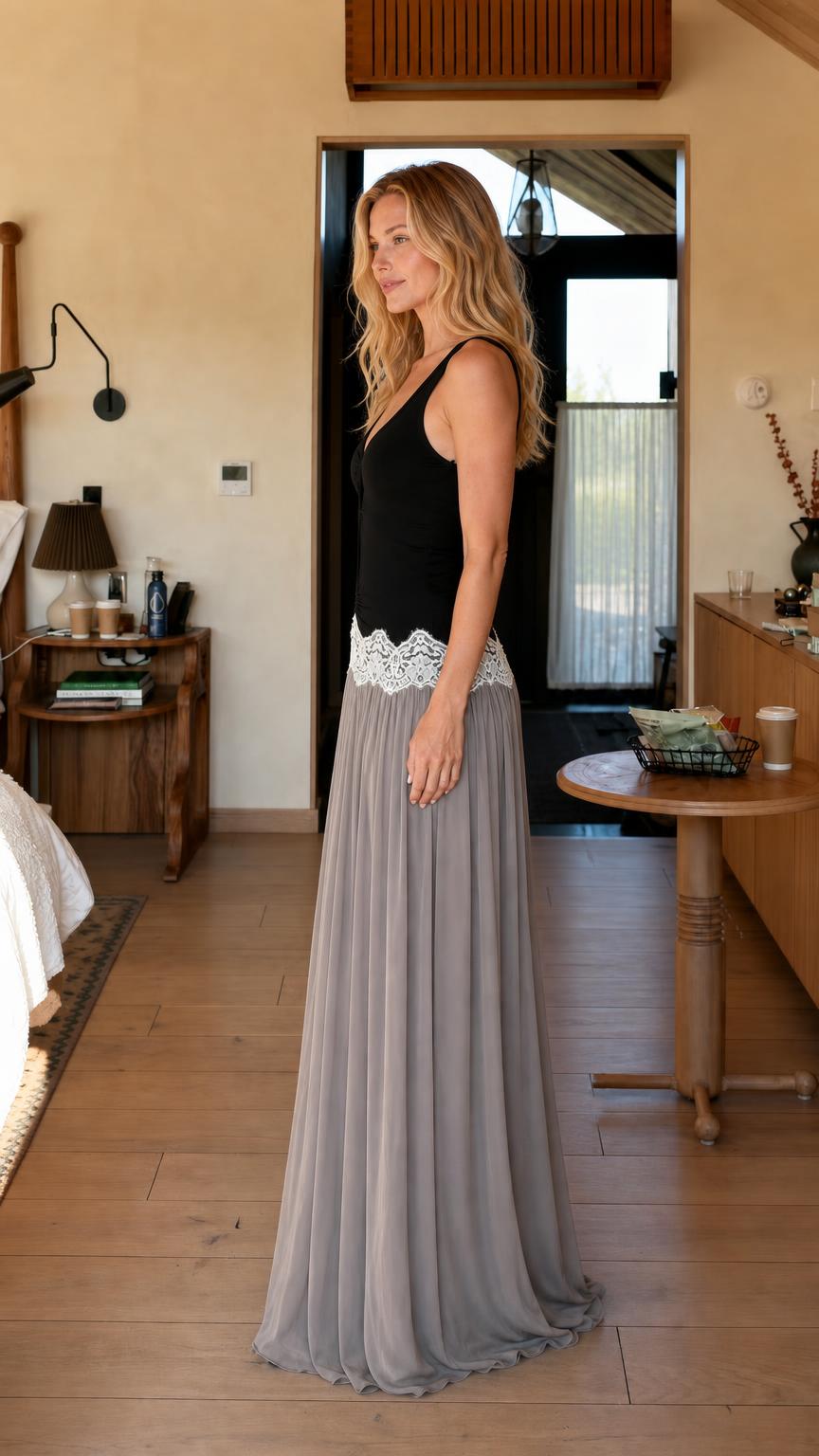 Side profile view of woman wearing black and grey lace-trimmed maxi dress