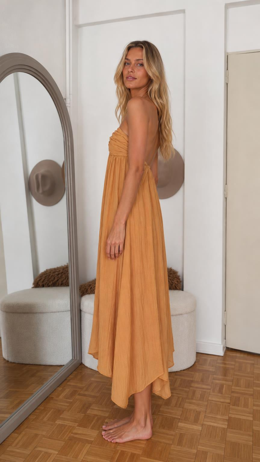 Side profile view of mustard yellow maxi dress with asymmetric hem