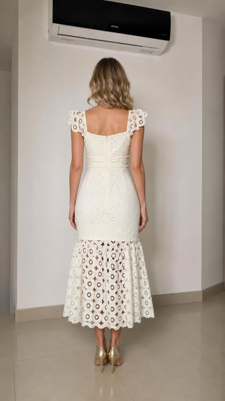 Back view of woman wearing white lace dress