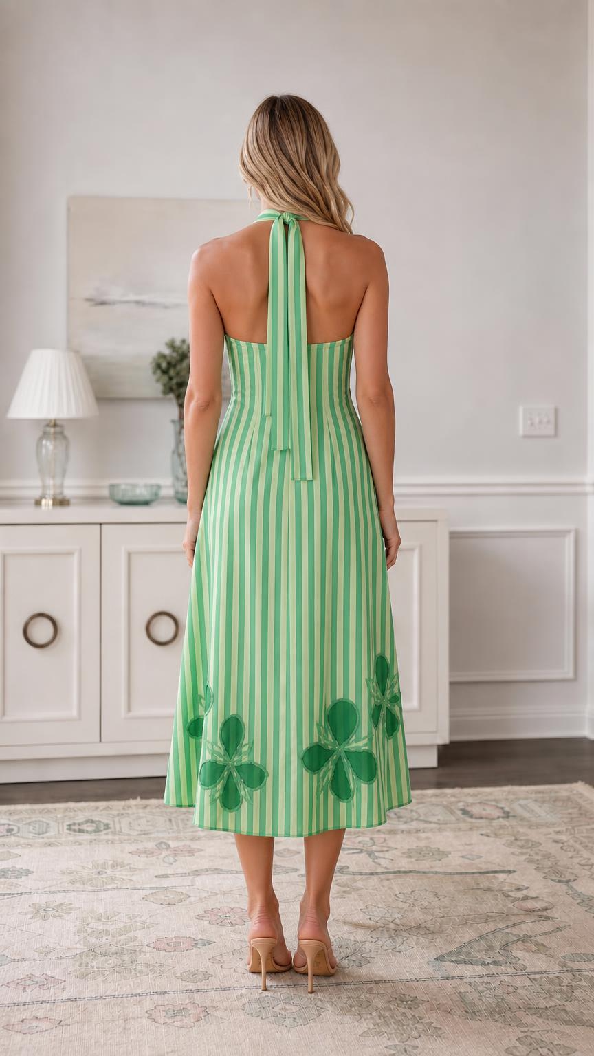 Back view of green striped midi dress showing halter ties