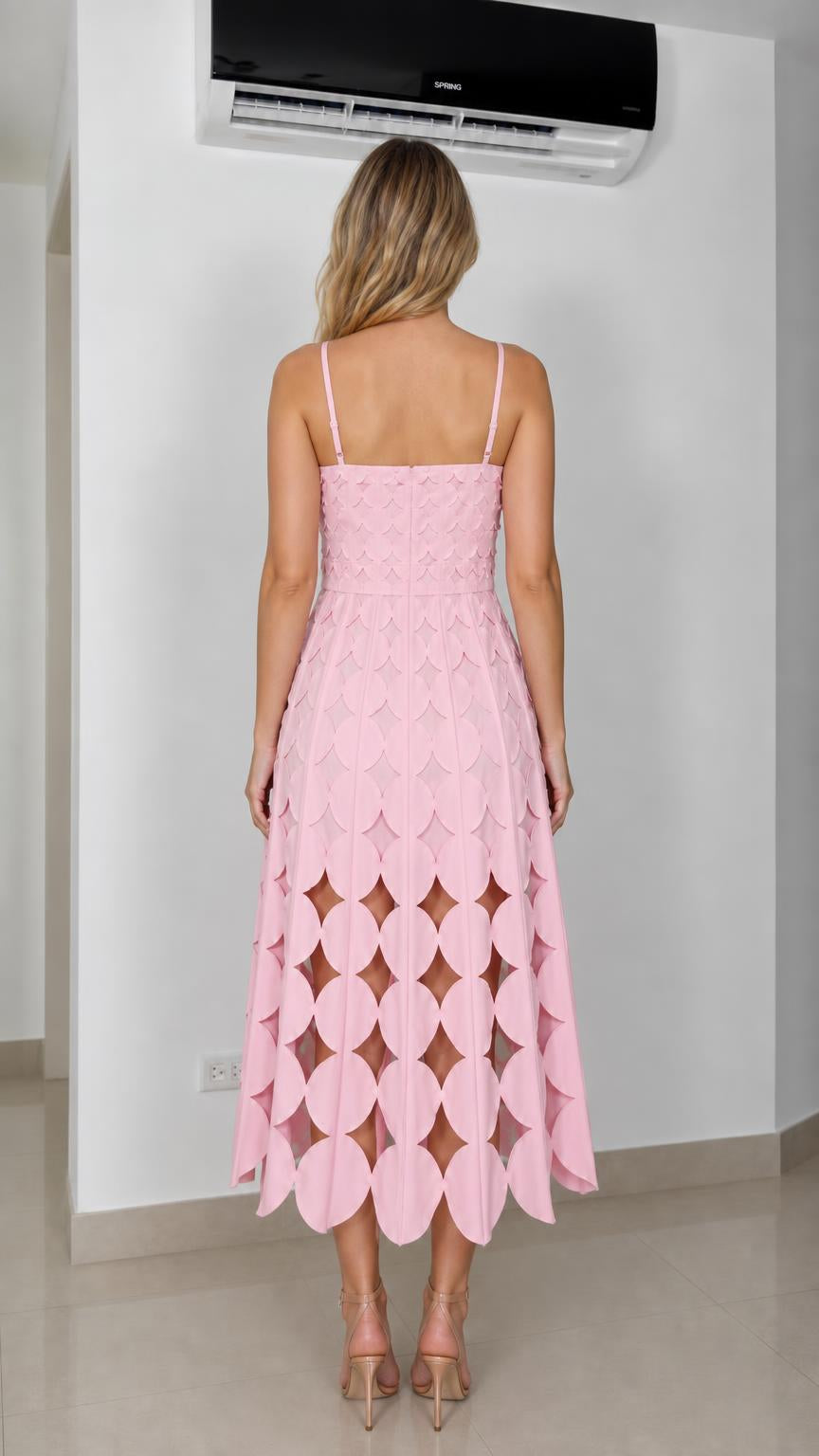 Back view of model showcasing pink midi dress with thin straps