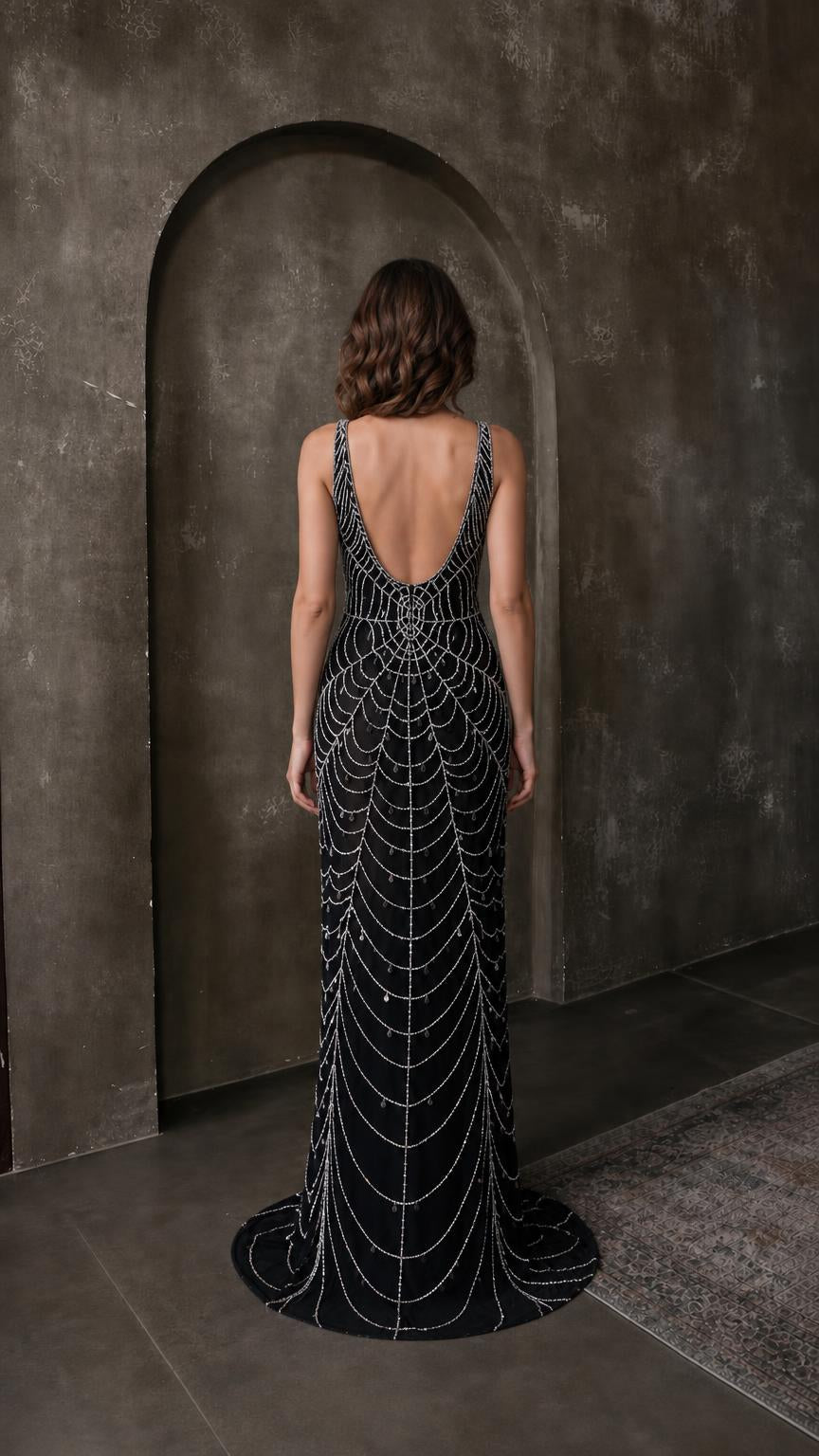 Back view of black beaded evening gown showing scoop back