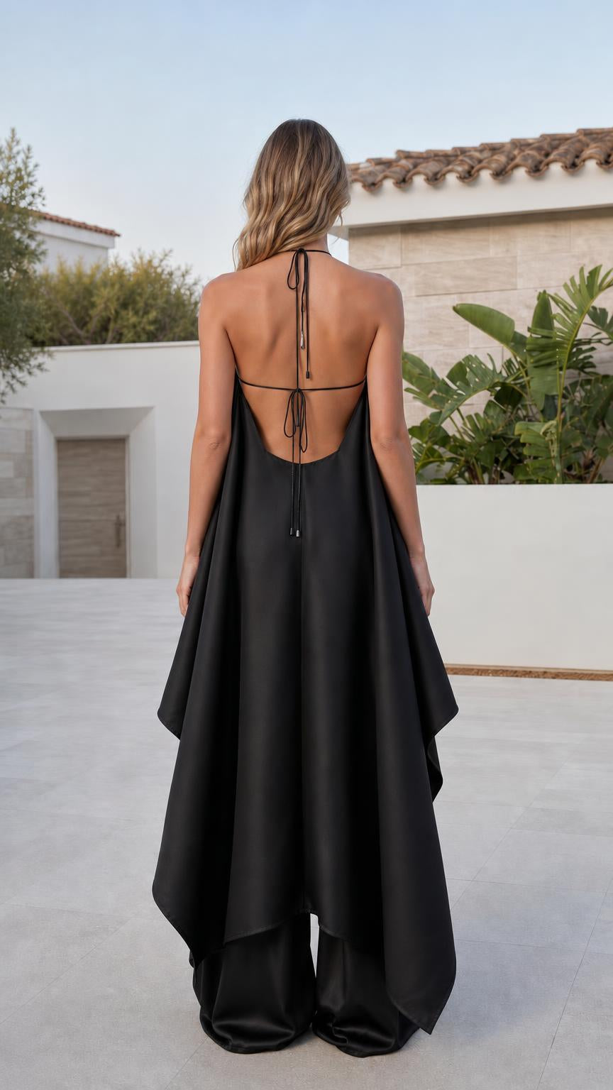 Back view showing open back ties on black jumpsuit