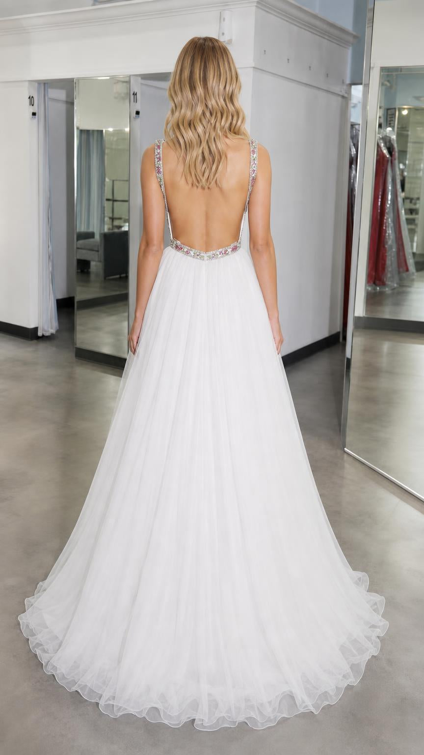 Back view showing open back of white tulle ball gown