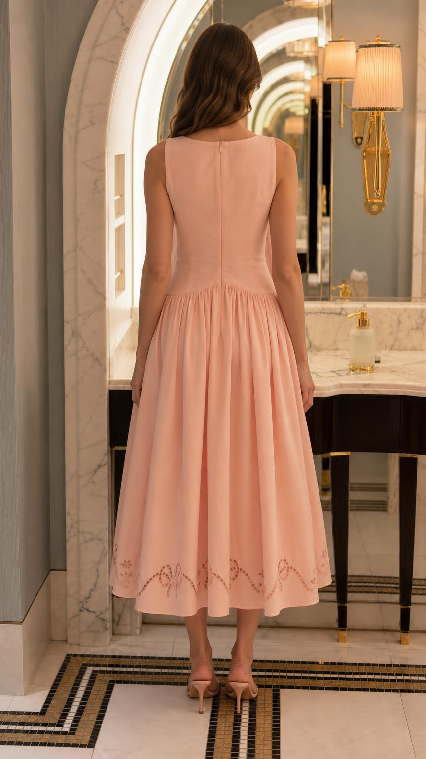 Back view of model in peach midi dress
