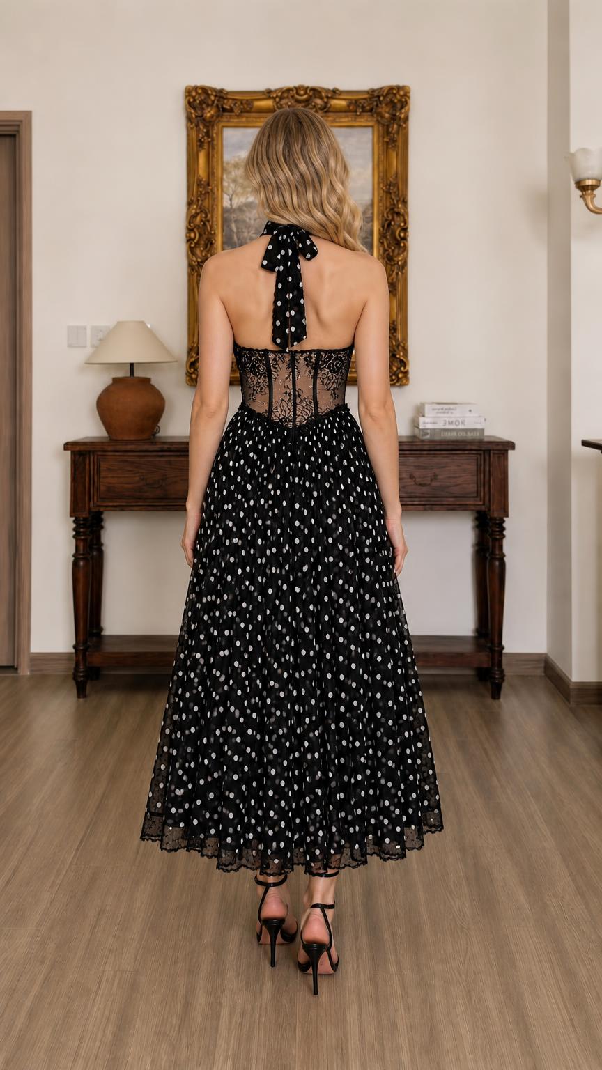 Back view of black polka dot halter midi dress showing tie closure