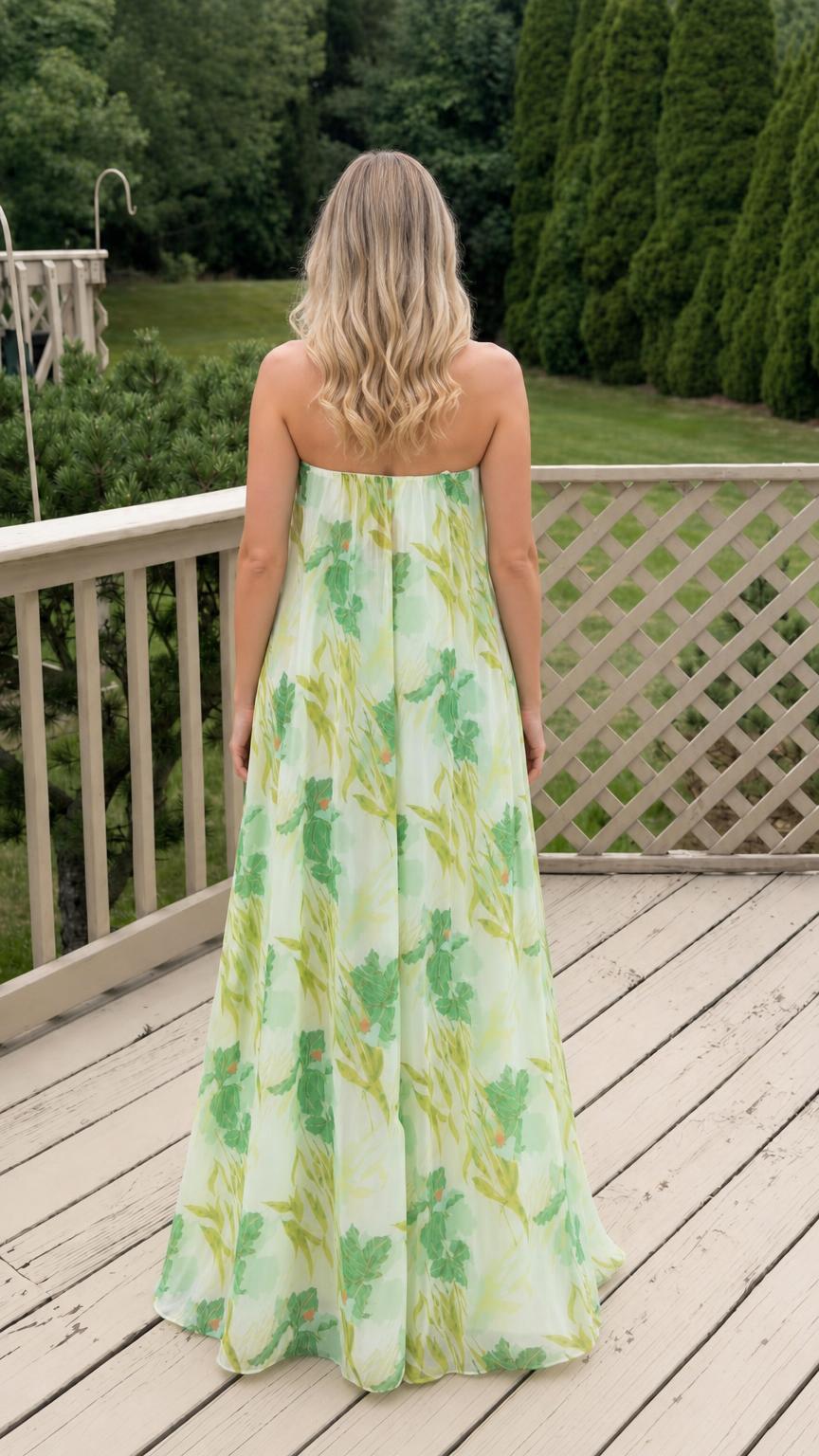 Back view of model in white floral strapless maxi dress