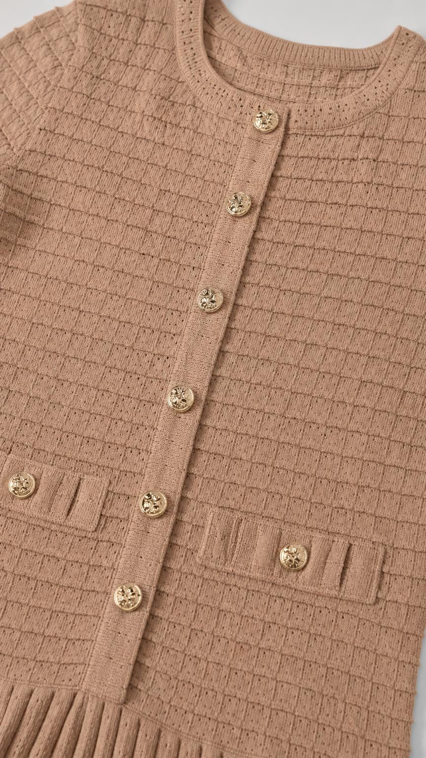 Close-up detail of knit texture and gold buttons