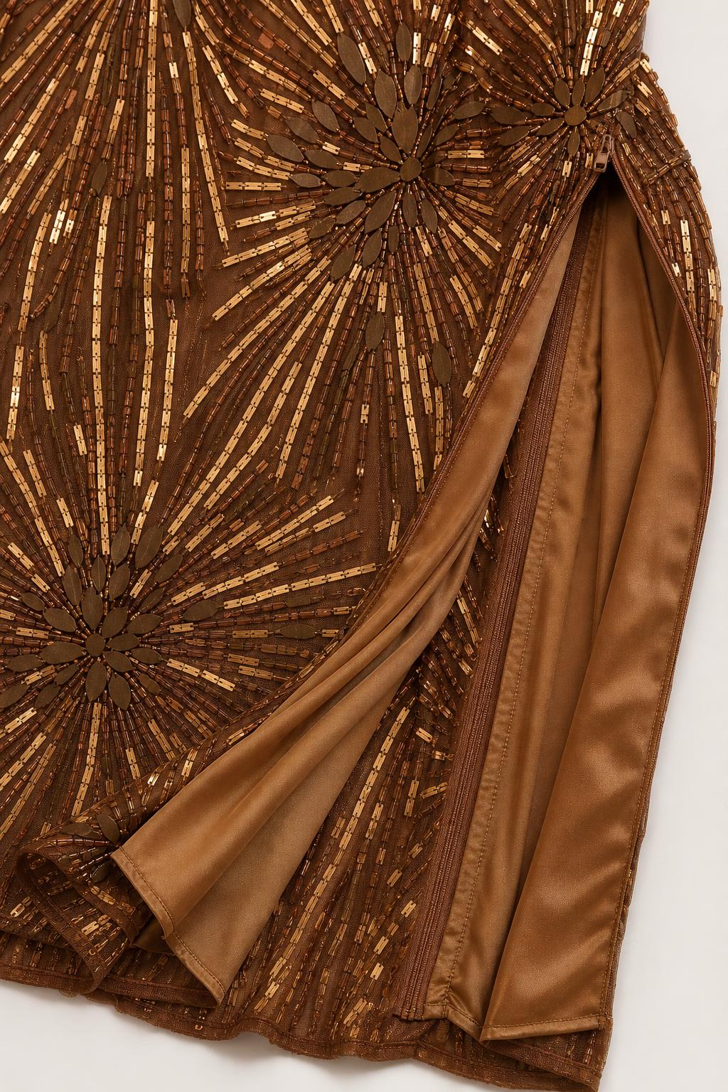 Close-up detail of the beadwork and side slit on bronze gown