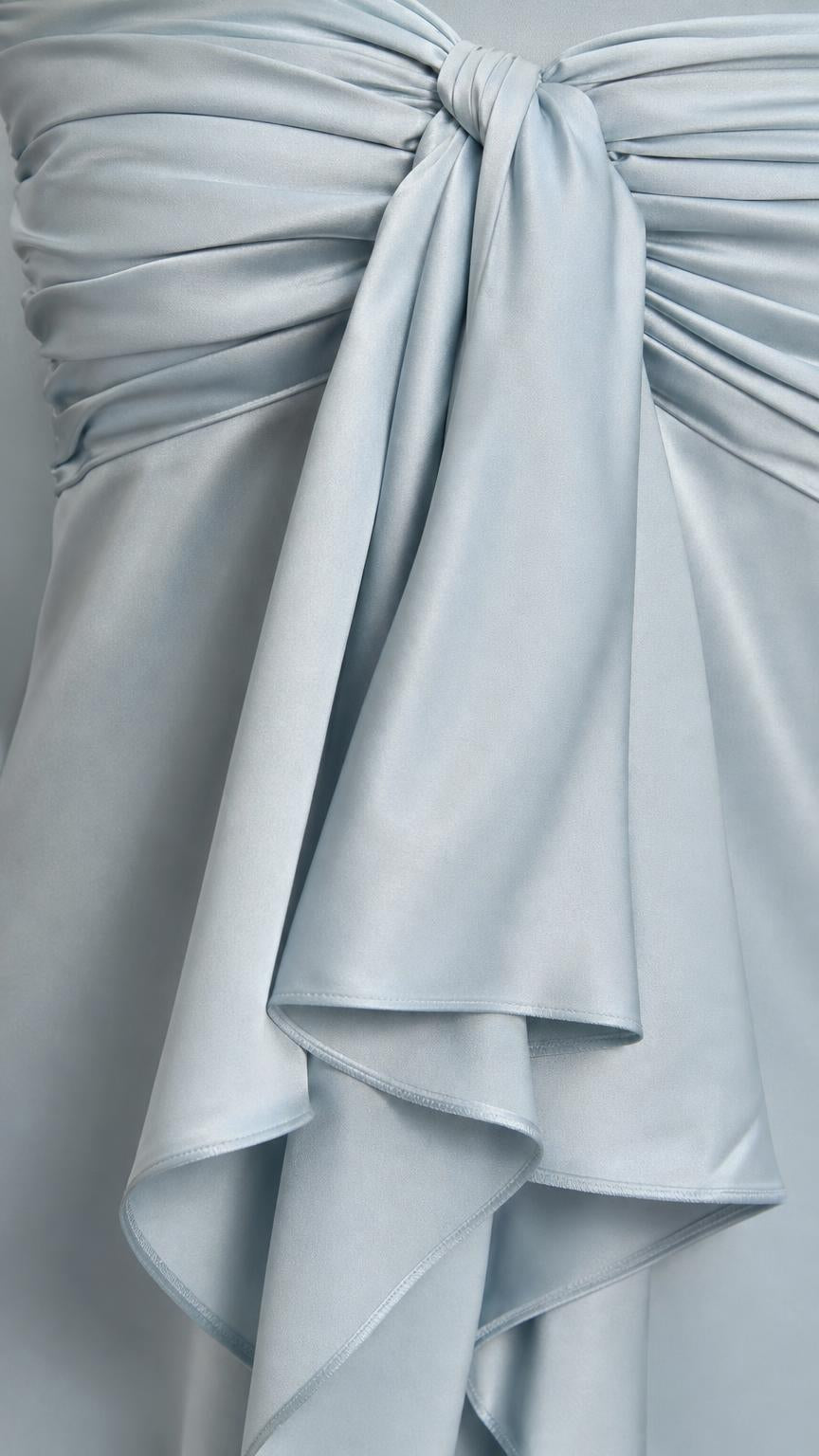 Close-up detail of the bodice bow and satin ruffles