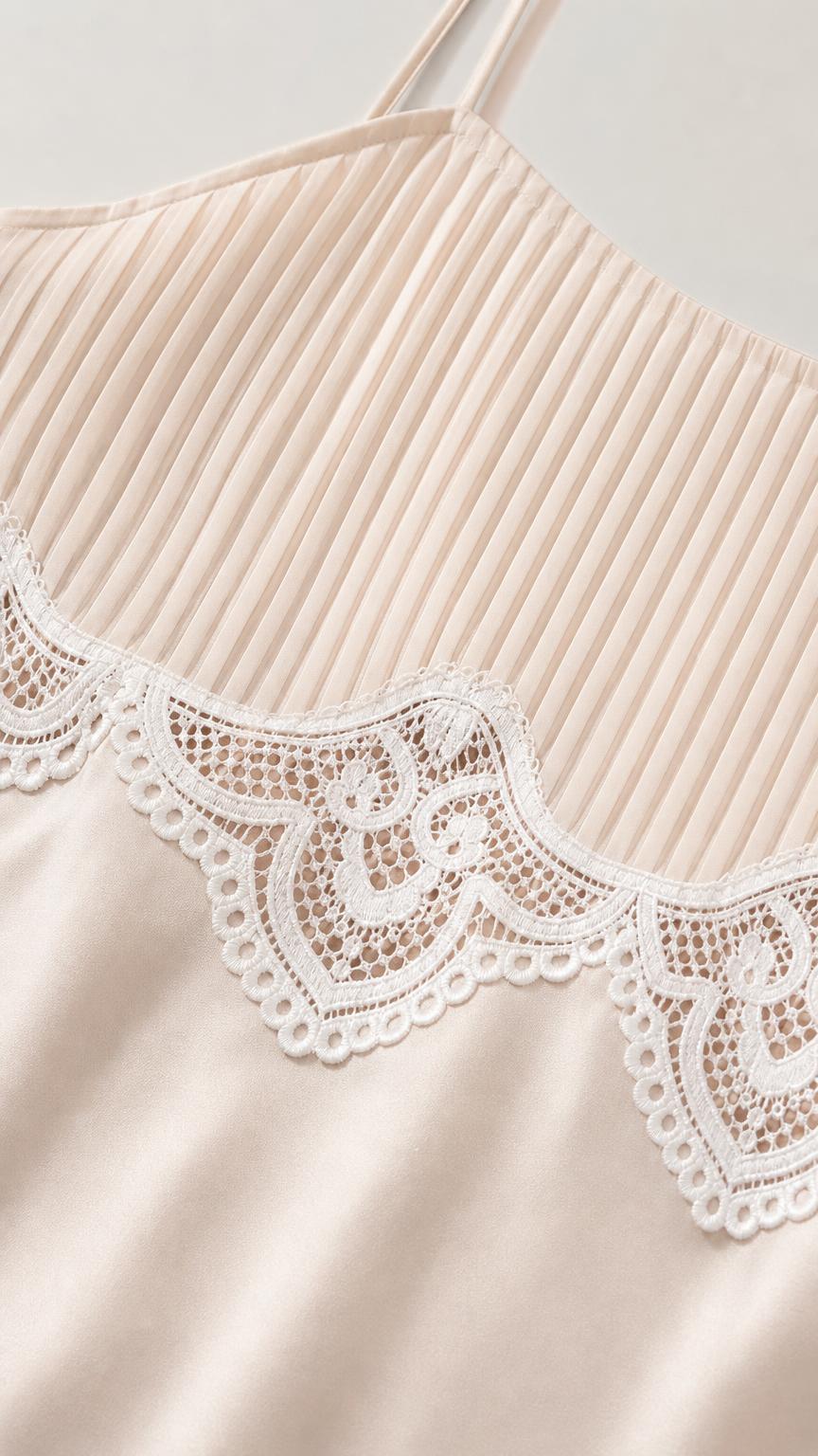 Close-up detail of pleated bodice and white lace trim