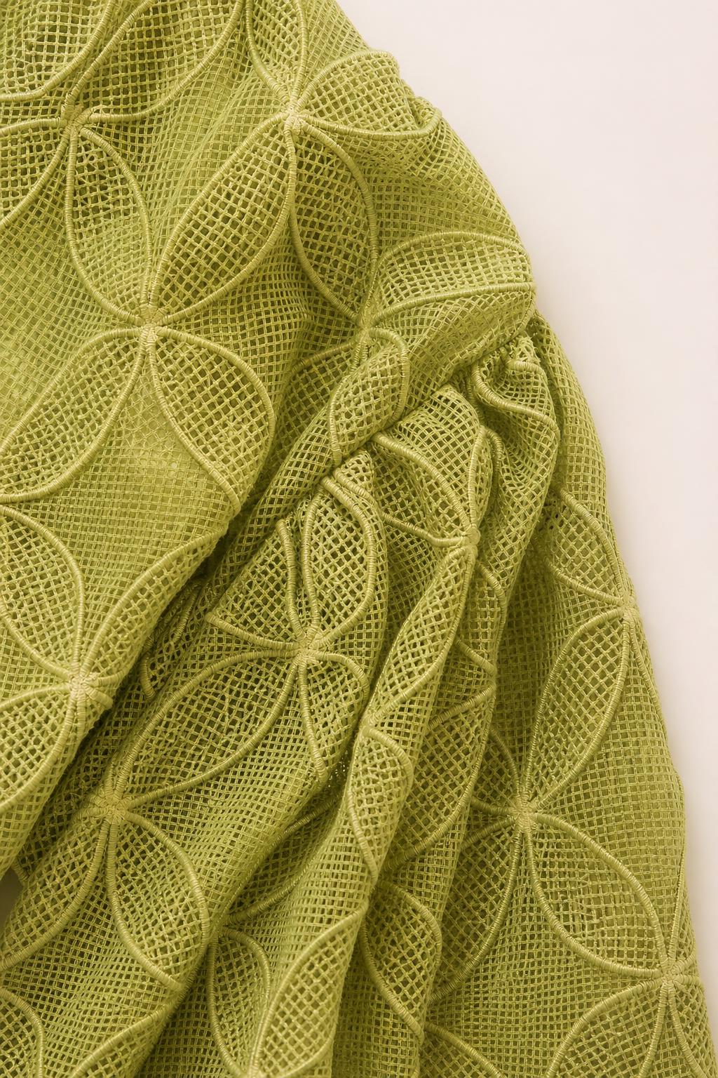 Close-up detail of the geometric textured olive fabric