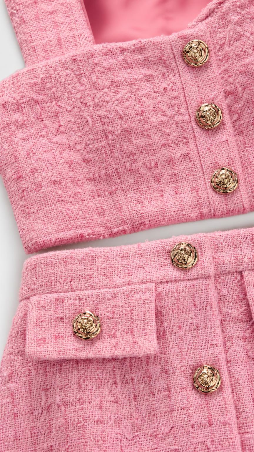 Close up of pink tweed texture and metallic buttons
