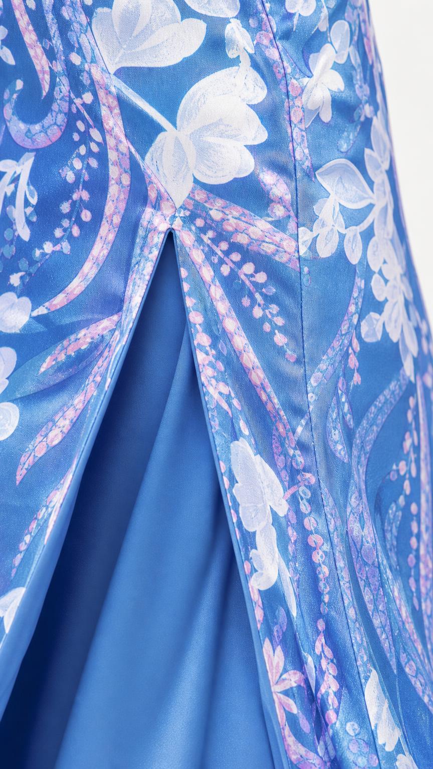 Close-up detail of fabric, pattern, and slit hem of blue dress