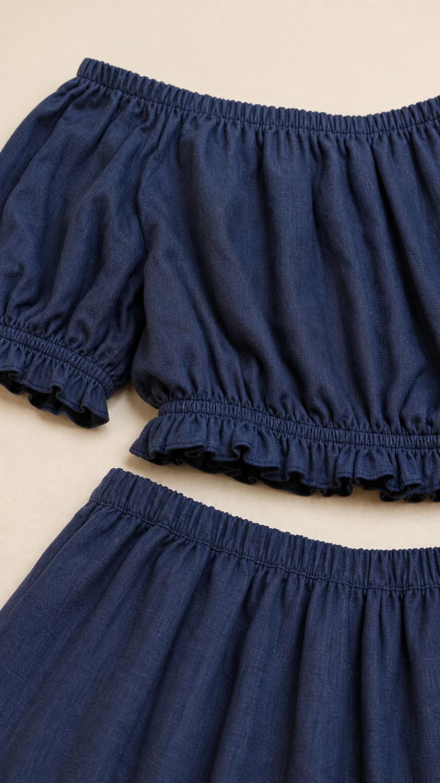 Close-up detail of blue off-shoulder top and elastic skirt waistband