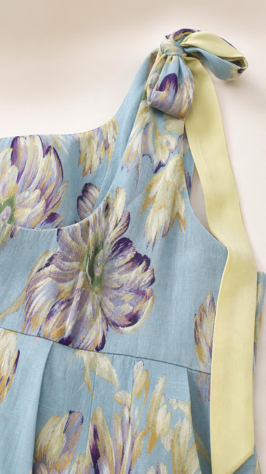 Close-up detail of shoulder bow tie and blue floral print fabric