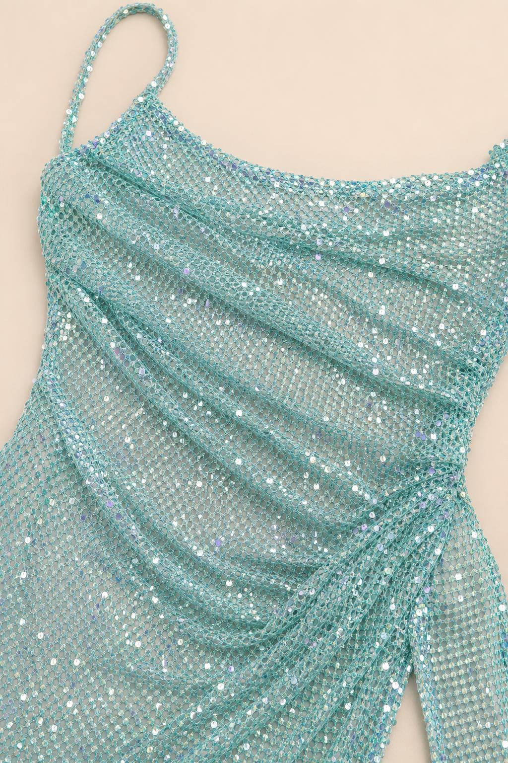 Close up fabric detail of turquoise sequin mesh material