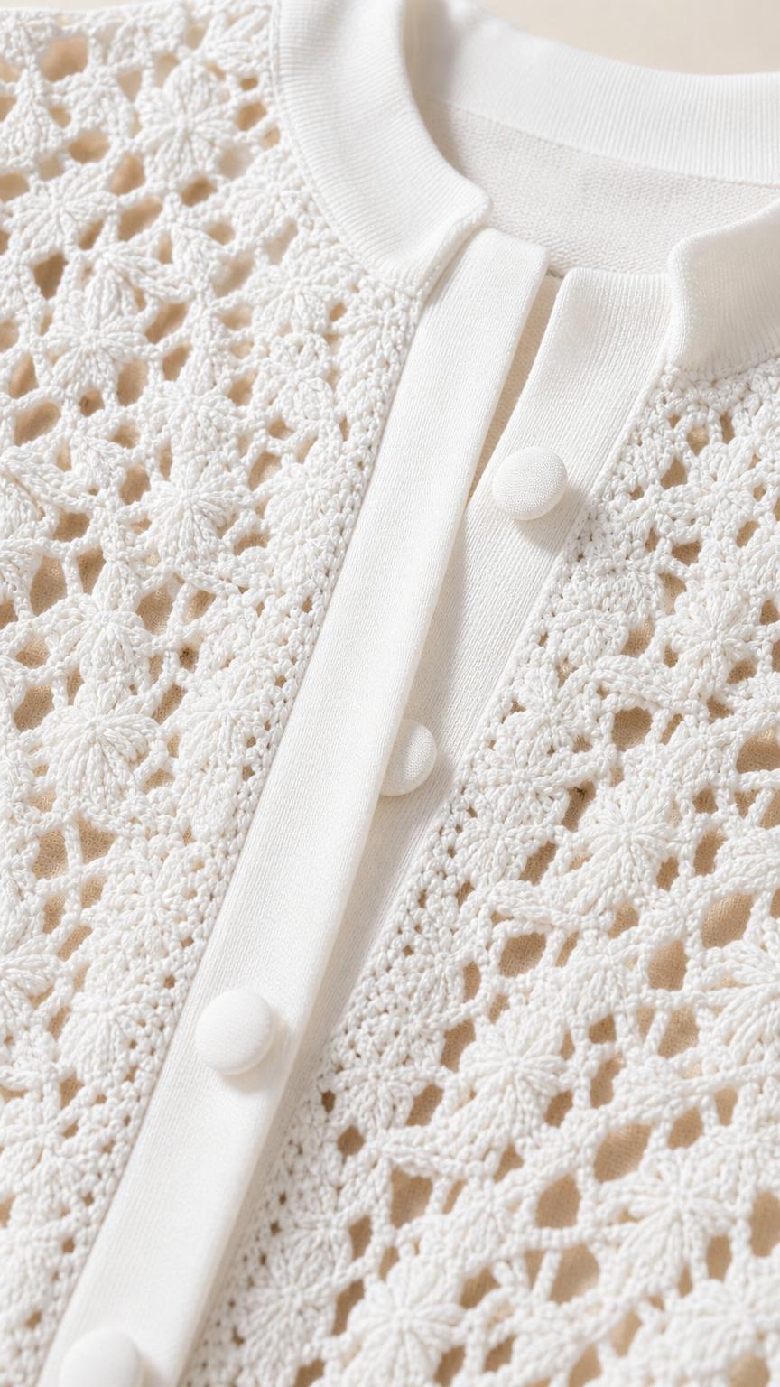 Close-up detail of white knit texture and button placket