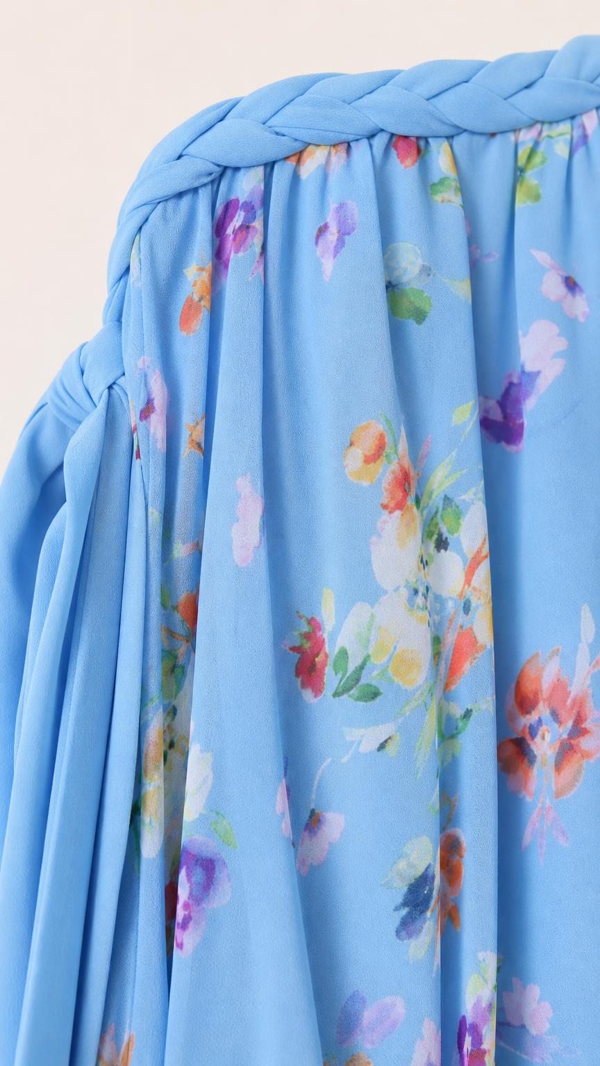 Close-up of braided neckline and floral print fabric