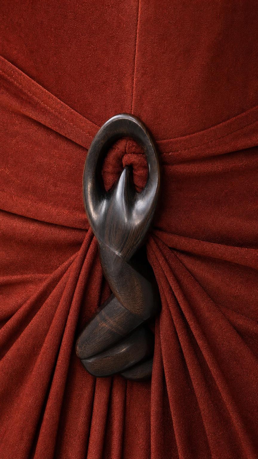 Close-up detail of carved wooden ring accent on dress