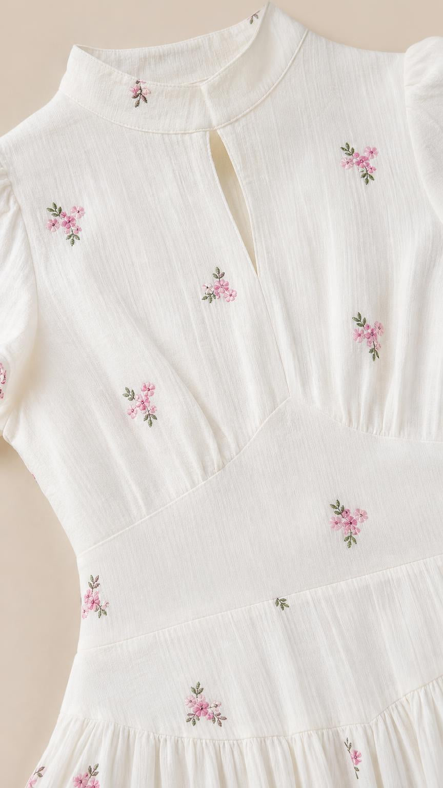 Close-up of high neck keyhole and embroidery detail