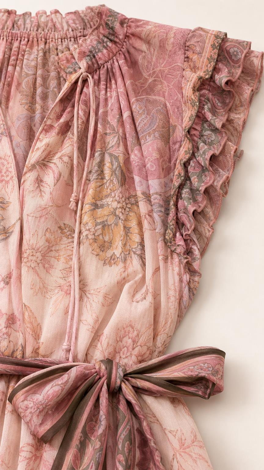 Closeup detail of bodice, ruffle sleeves, and waist tie