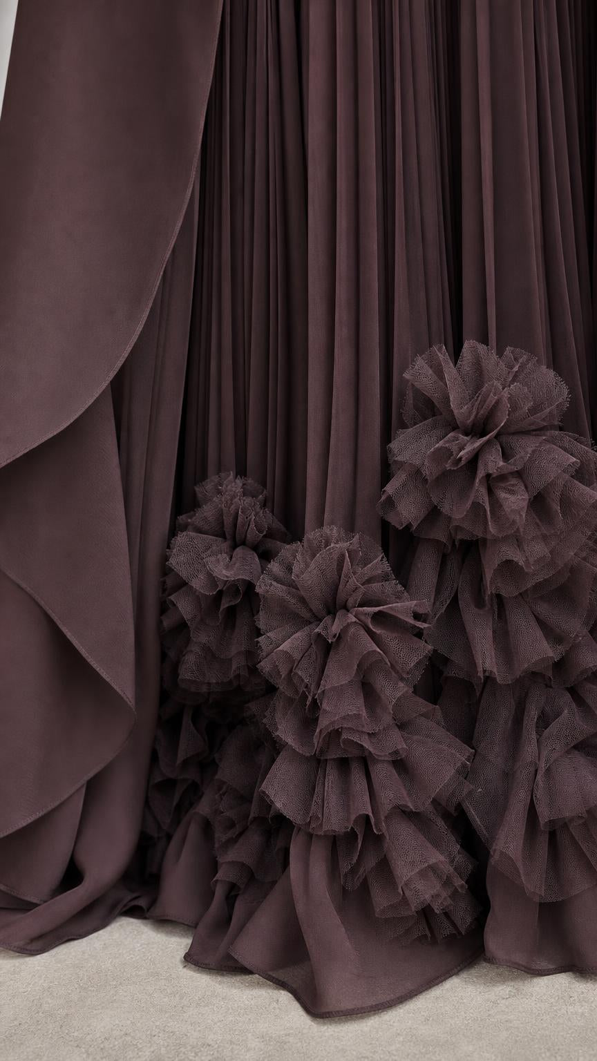 Close-up of pleated skirt and dimensional ruffled hem details