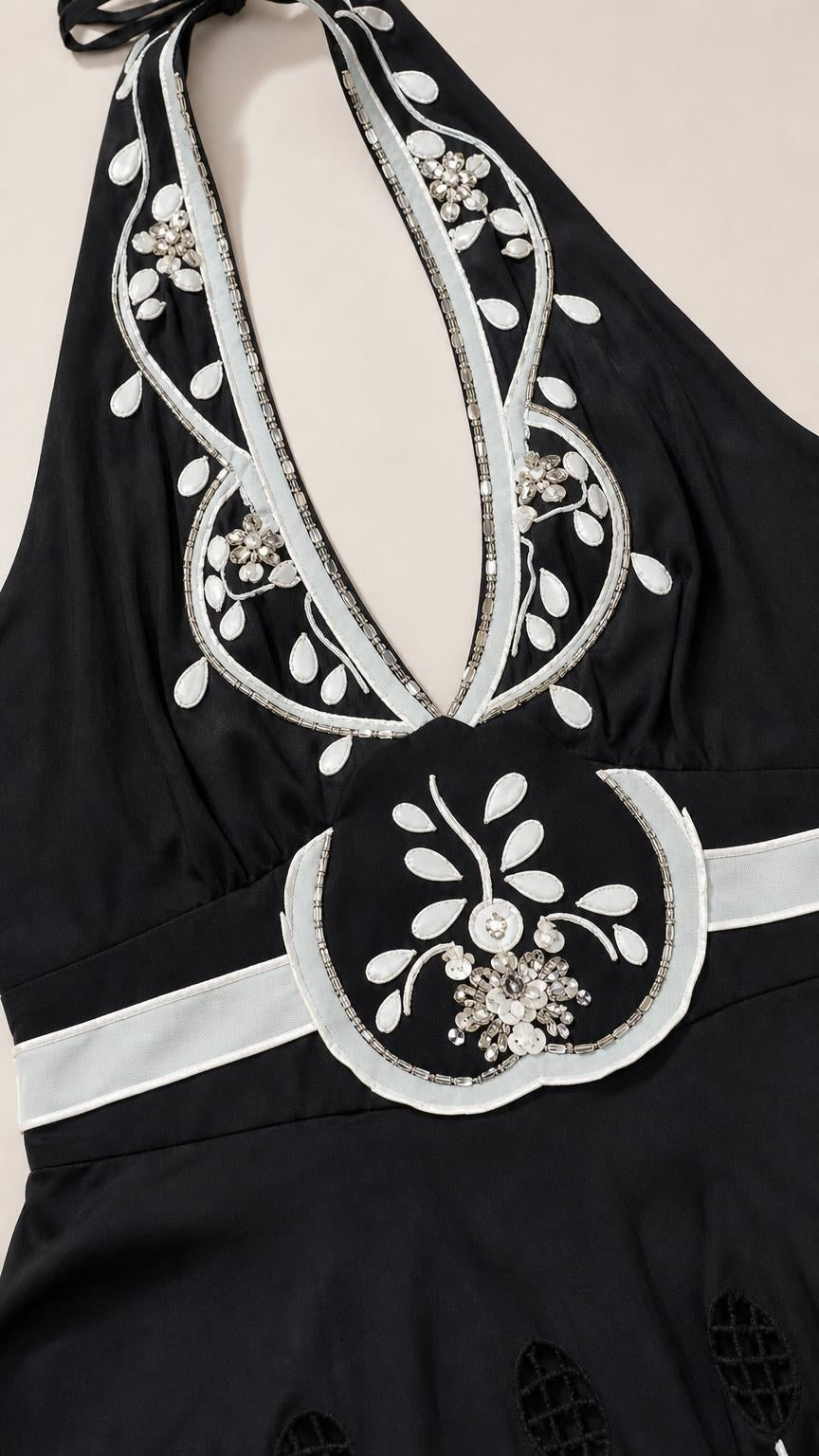 Close up of neckline and embroidery detail on black dress