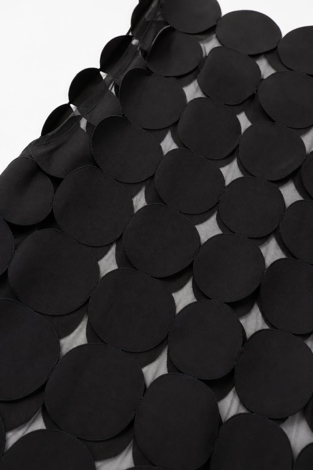 Close-up detail of smooth black circular fabric appliques