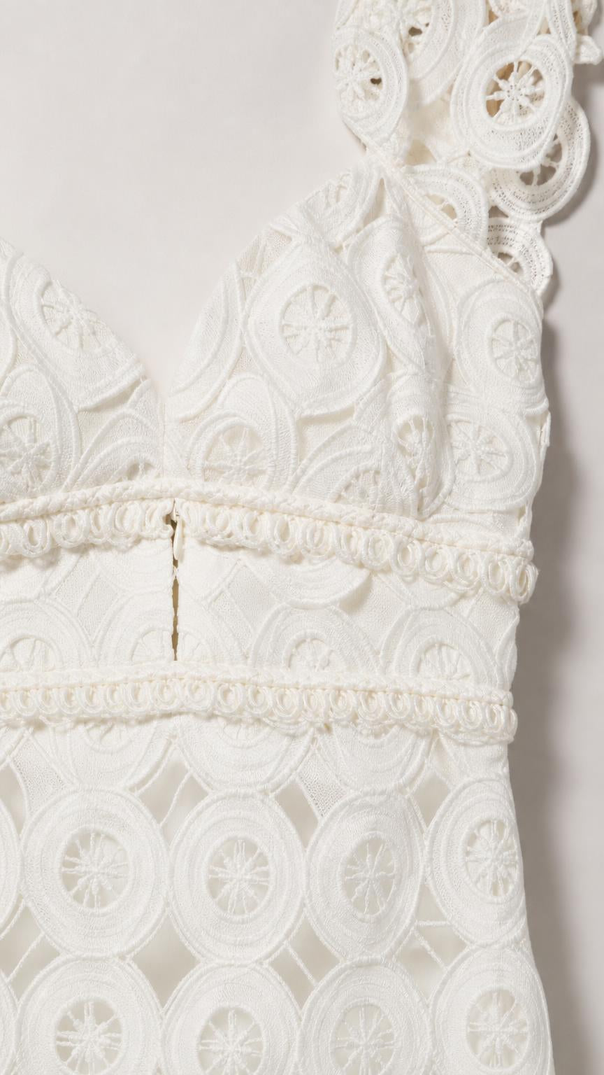 Close-up detail of white lace bodice and cutout pattern