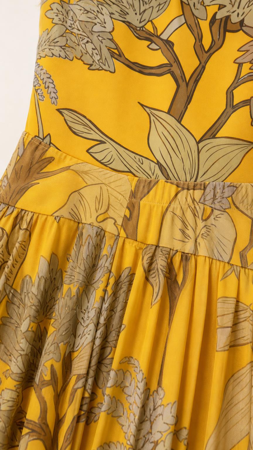 Close-up detail of fabric, bodice, and botanical print on yellow dress